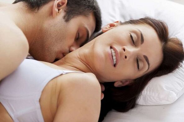 Excited men and women in bed